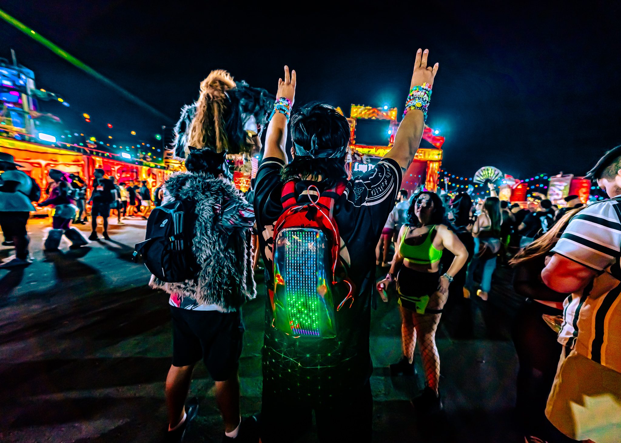 Festival-goer arms up with LED Lunchbox pack in crowd